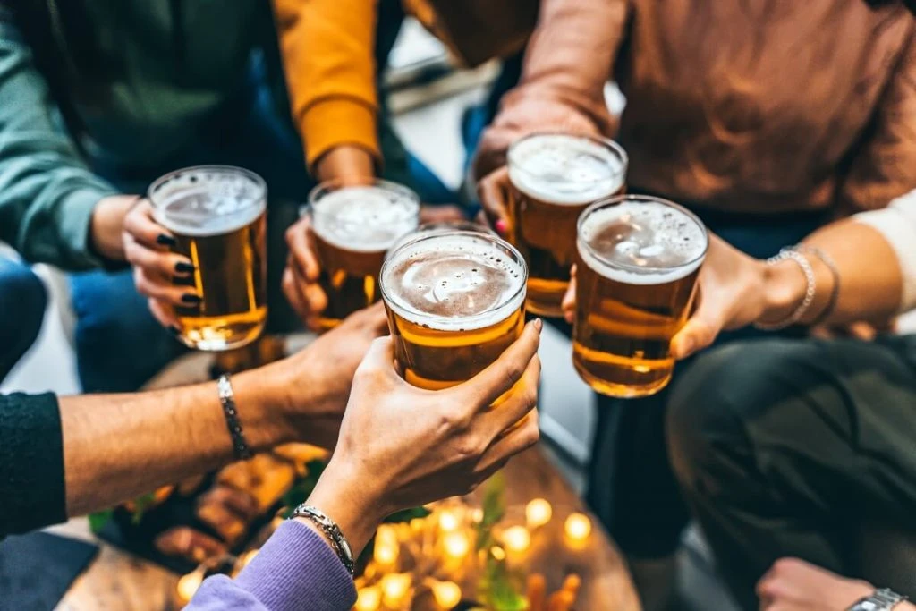 People drinking a beer at the opening of a new bar