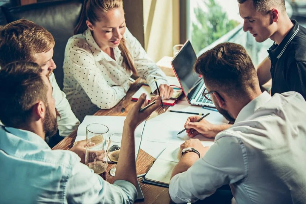 A group of people working on a business plan for a pub