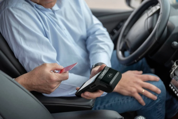 La convenienza dei pagamenti contactless - Un tassista accetta il pagamento contactless tramite POS
